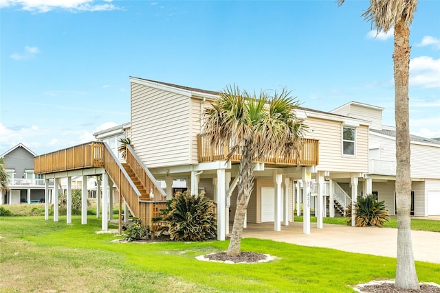 view of front of home featuring stairs, concrete driveway, and a front lawn