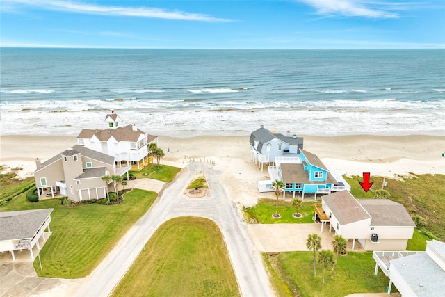 drone / aerial view with a water view and a view of the beach