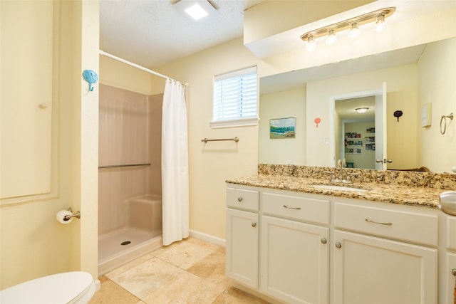 full bathroom featuring curtained shower, toilet, vanity, baseboards, and tile patterned floors