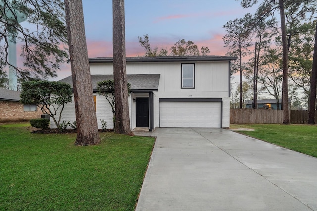 front facade featuring a lawn and a garage