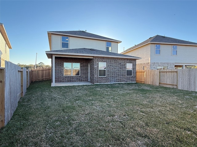 back of house featuring a patio area and a lawn