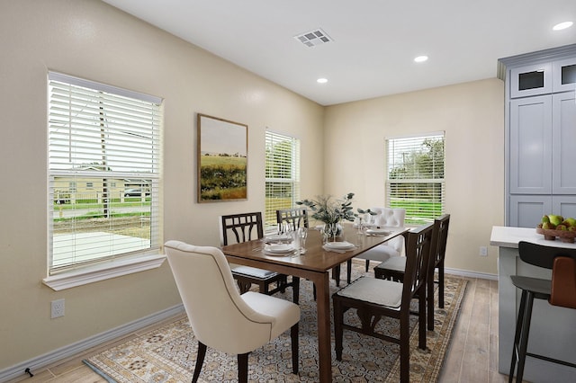 dining space with light hardwood / wood-style flooring