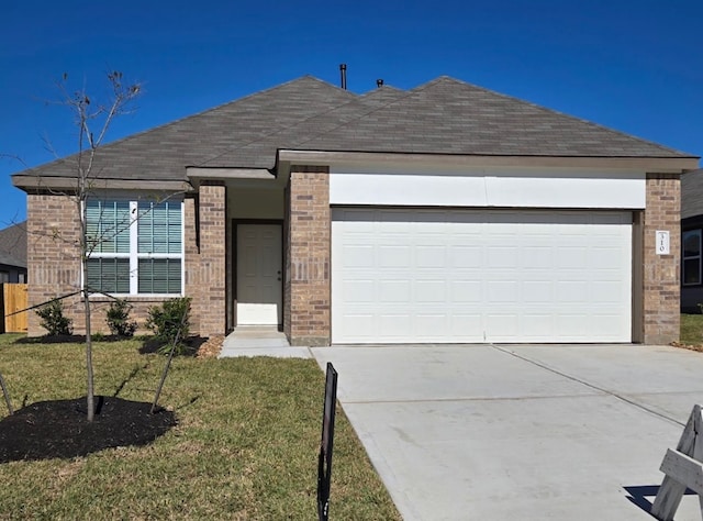 view of front of house with a front yard and a garage