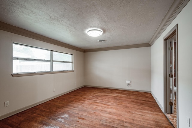 empty room featuring ornamental molding, a textured ceiling, and light hardwood / wood-style flooring