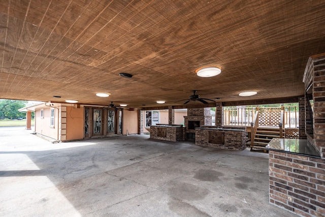 misc room featuring concrete floors, ceiling fan, and wood ceiling