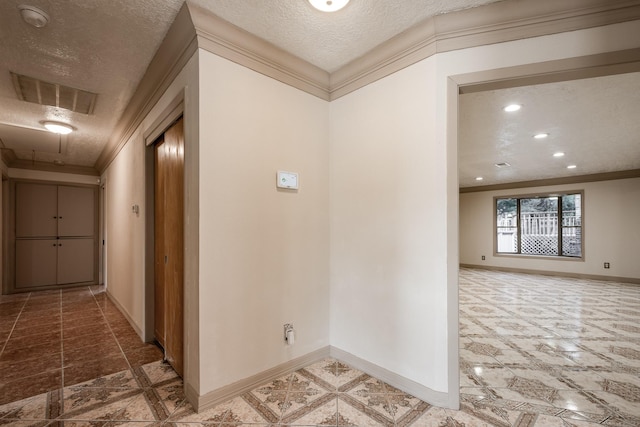 hallway featuring crown molding and a textured ceiling