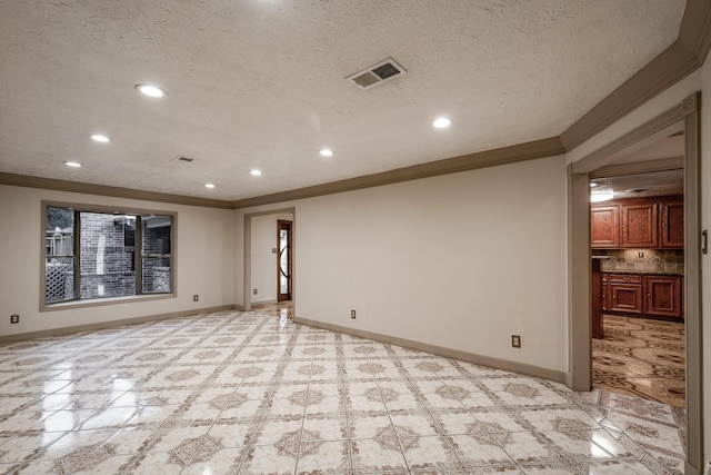 unfurnished room featuring crown molding and a textured ceiling