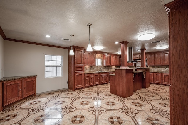 kitchen with a kitchen breakfast bar, backsplash, crown molding, pendant lighting, and a kitchen island