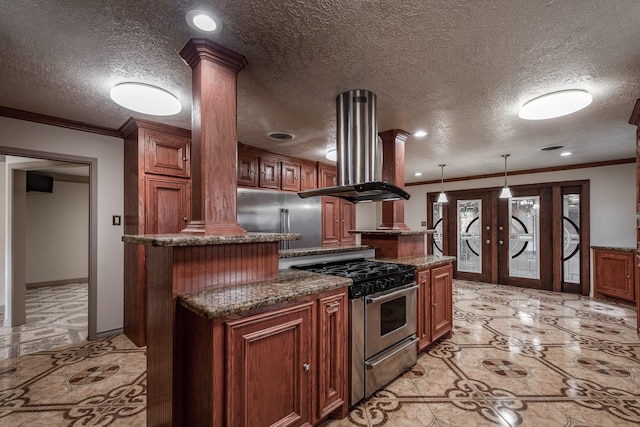 kitchen with ornate columns, a center island, and appliances with stainless steel finishes