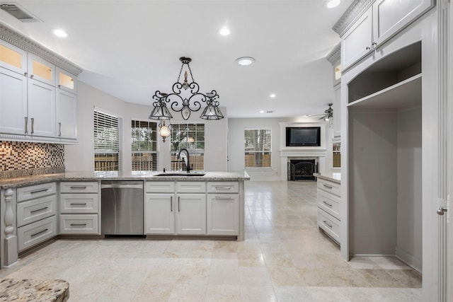 kitchen featuring sink, a wealth of natural light, hanging light fixtures, and dishwasher