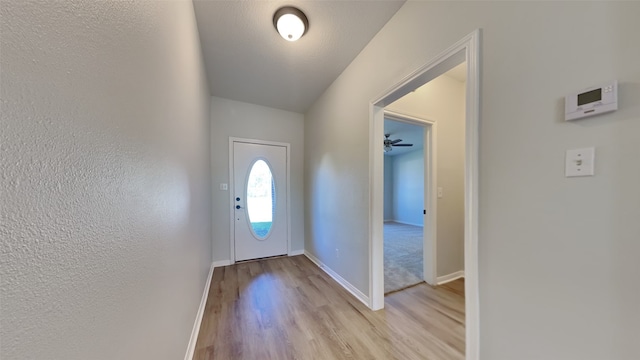 entryway featuring ceiling fan, a textured ceiling, and light hardwood / wood-style flooring