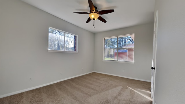 carpeted empty room featuring ceiling fan