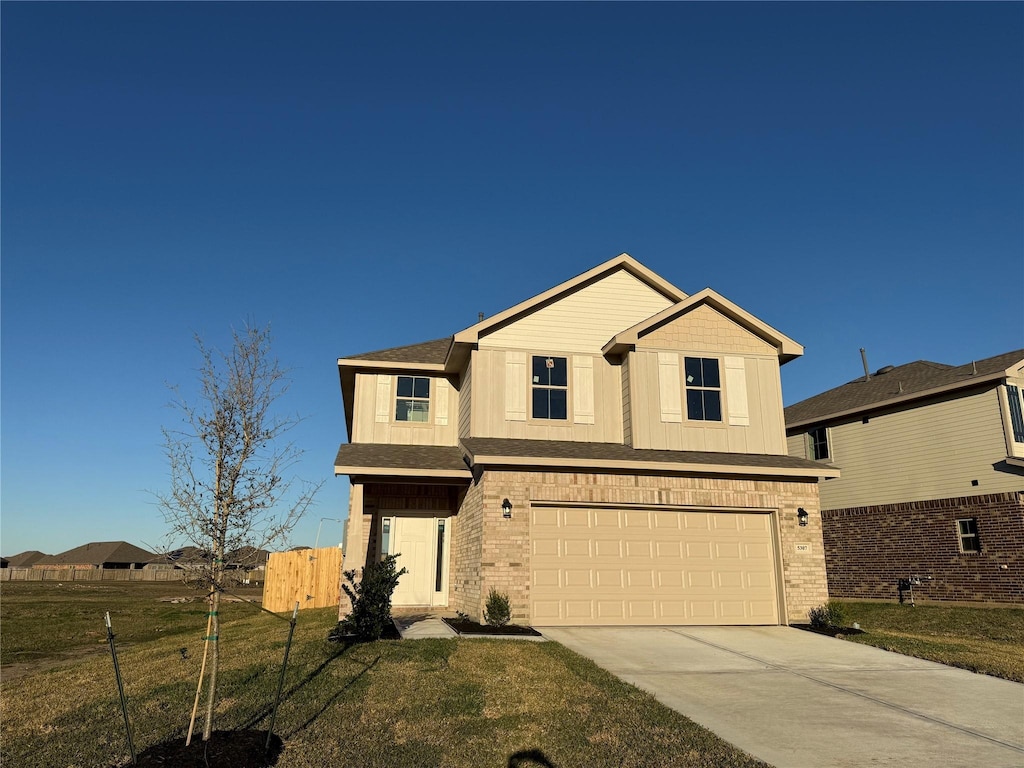 view of front of home featuring a garage and a front lawn