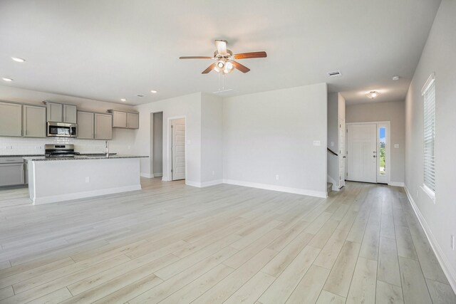 5307 W Bayou Maison Cir, Dickinson, TX 77539 - unfurnished living room with ceiling fan, light wood-style floors, recessed lighting, and stairway
