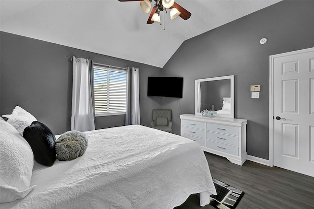 bedroom with ceiling fan, dark hardwood / wood-style flooring, and lofted ceiling