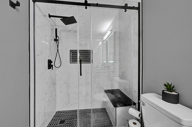 bathroom featuring toilet and an enclosed shower