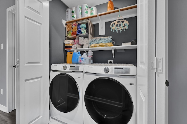 clothes washing area with separate washer and dryer and hardwood / wood-style flooring