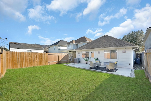 back of house featuring a lawn, a patio area, and central air condition unit