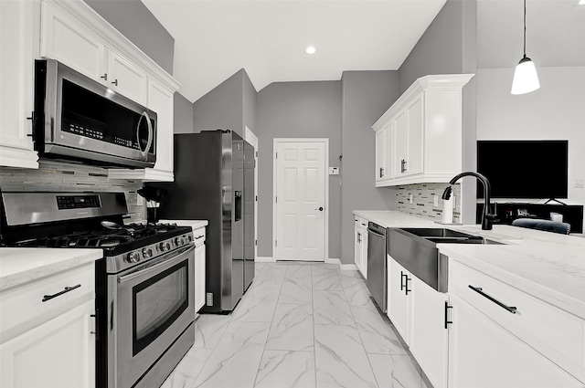 kitchen featuring white cabinetry, hanging light fixtures, and stainless steel appliances