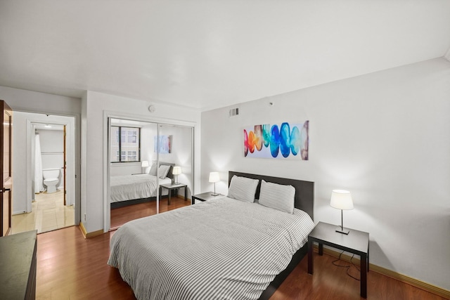 bedroom with hardwood / wood-style flooring and a closet