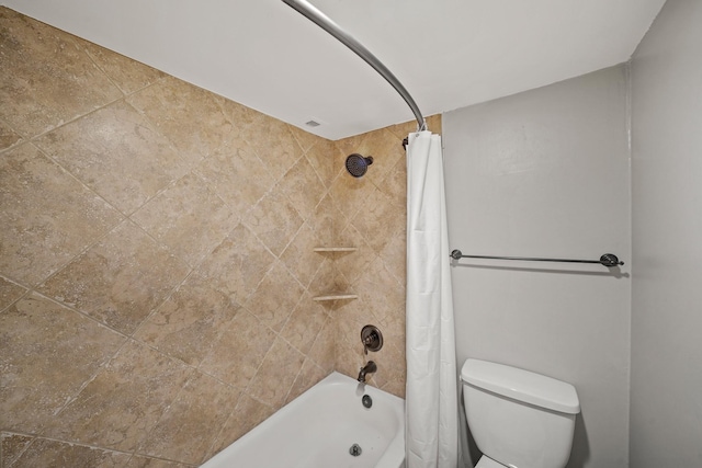 bathroom featuring shower / tub combo and toilet