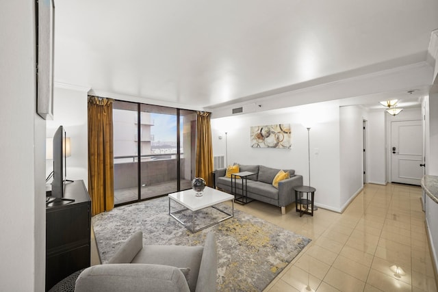 living room with light tile patterned floors, a wall of windows, and ornamental molding