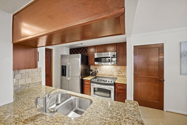 kitchen with sink, light stone counters, backsplash, crown molding, and appliances with stainless steel finishes