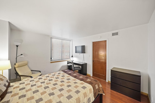 bedroom with hardwood / wood-style flooring