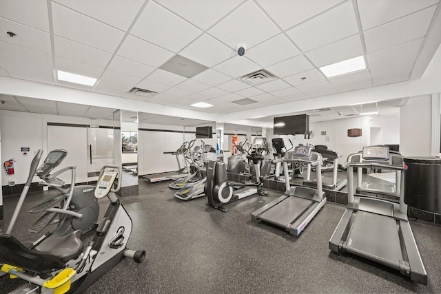 exercise room with a drop ceiling