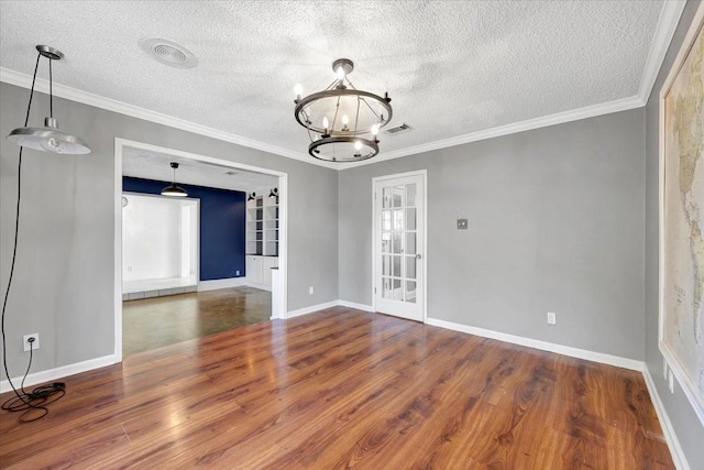 unfurnished dining area featuring a textured ceiling, hardwood / wood-style flooring, and an inviting chandelier