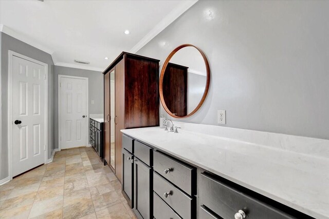 bathroom featuring vanity and ornamental molding