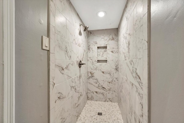 bathroom with tiled shower