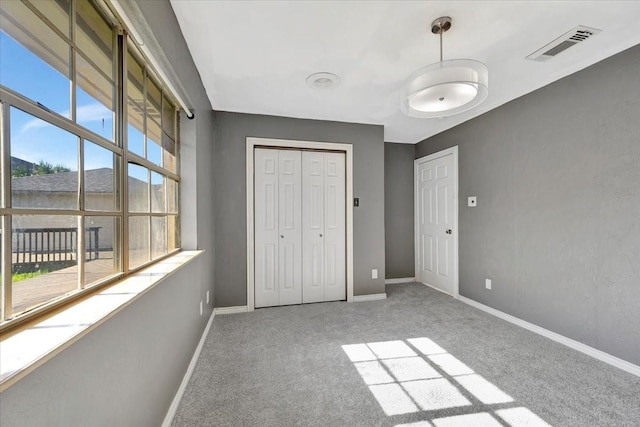 unfurnished bedroom with carpet flooring and a closet