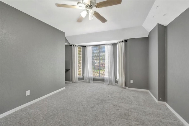 unfurnished room featuring ceiling fan, light colored carpet, and lofted ceiling