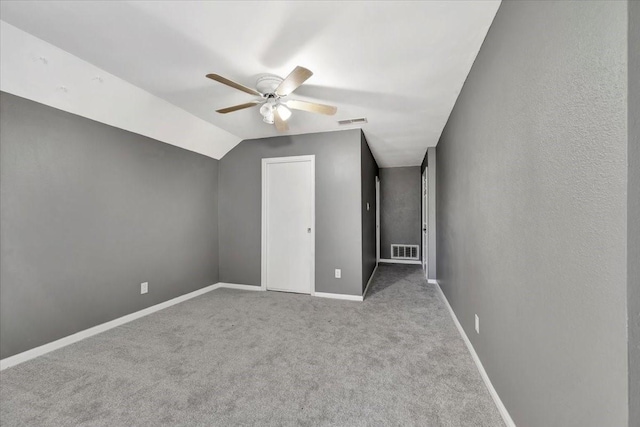 additional living space with ceiling fan, light carpet, and vaulted ceiling