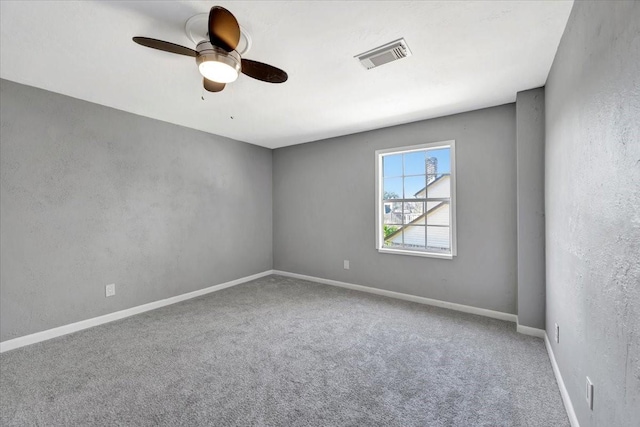 spare room featuring carpet flooring and ceiling fan