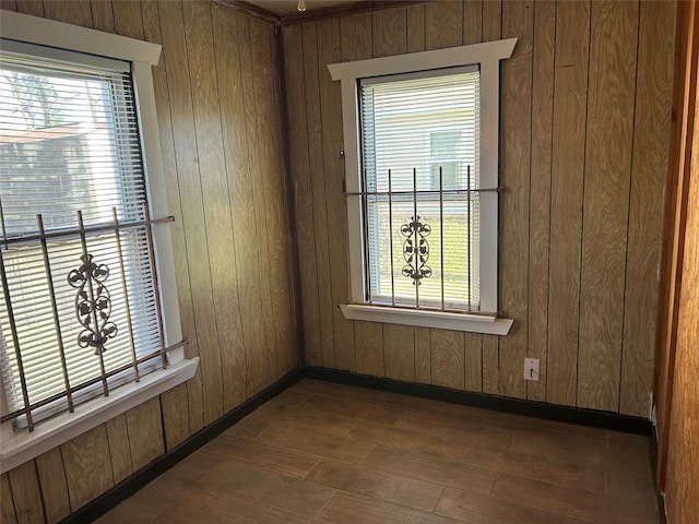 spare room featuring wooden walls