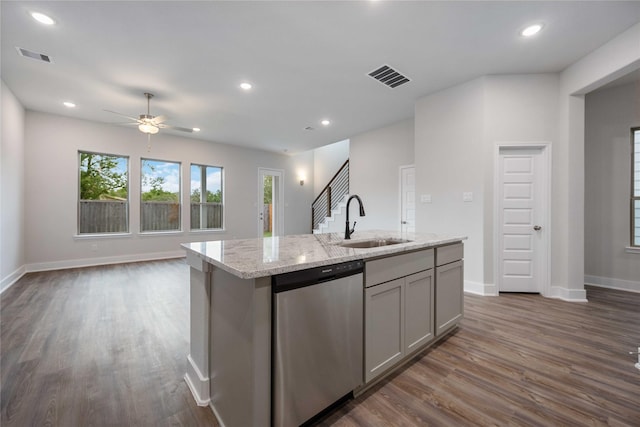 kitchen with gray cabinets, stainless steel dishwasher, a kitchen island with sink, and sink