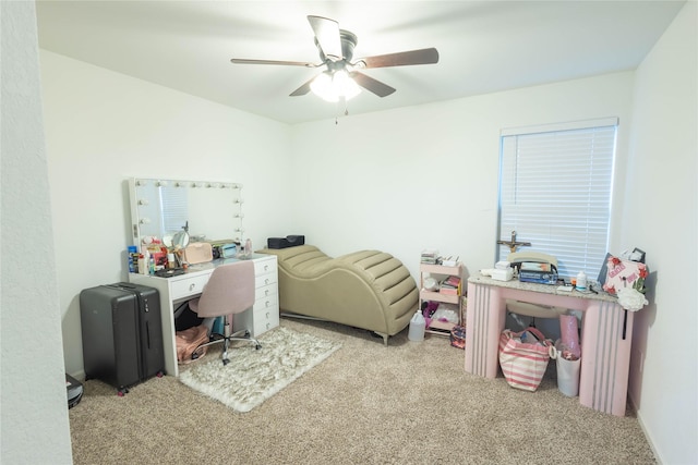 carpeted office space featuring ceiling fan