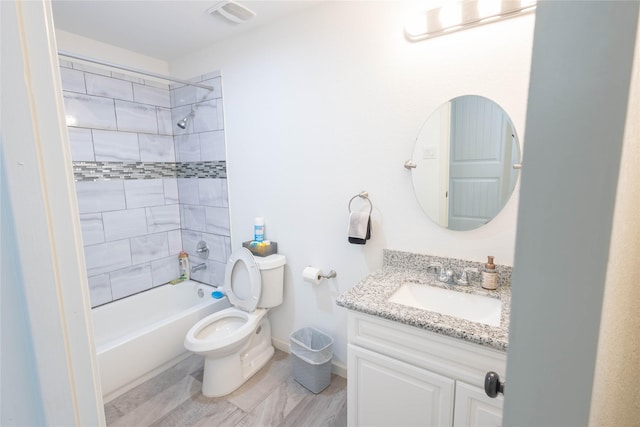 full bathroom with vanity, toilet, and tiled shower / bath