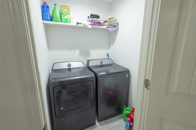 washroom with light tile patterned floors and separate washer and dryer