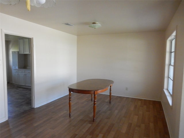 interior space with plenty of natural light and dark wood-type flooring