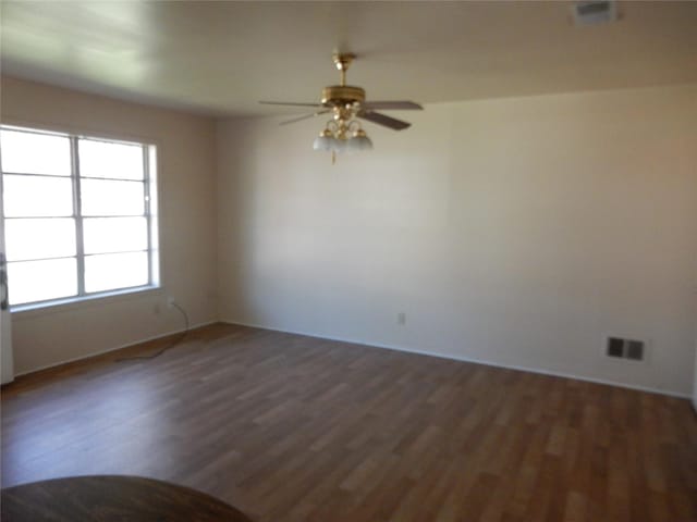 empty room featuring ceiling fan and dark wood-type flooring