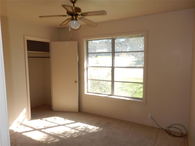 unfurnished bedroom featuring multiple windows, a closet, and ceiling fan