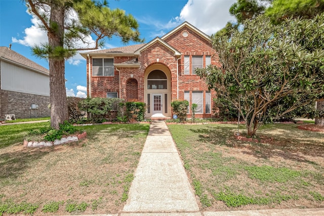 view of property featuring a front lawn