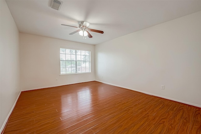 empty room featuring ceiling fan and hardwood / wood-style flooring