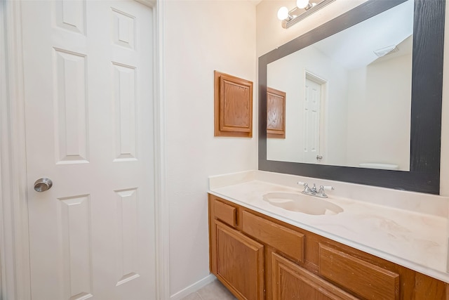 bathroom featuring tile patterned floors, vanity, and toilet