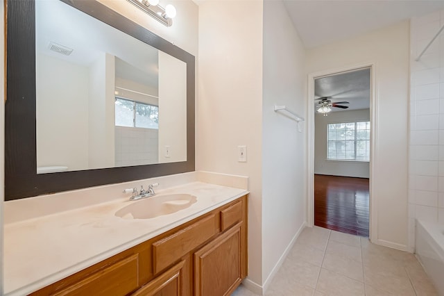 bathroom with tile patterned floors, vanity, ceiling fan, and bathtub / shower combination