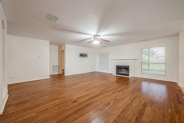 unfurnished living room with ceiling fan and hardwood / wood-style flooring