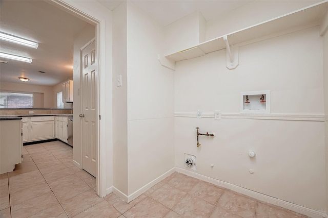 washroom with hookup for an electric dryer, gas dryer hookup, light tile patterned floors, and hookup for a washing machine